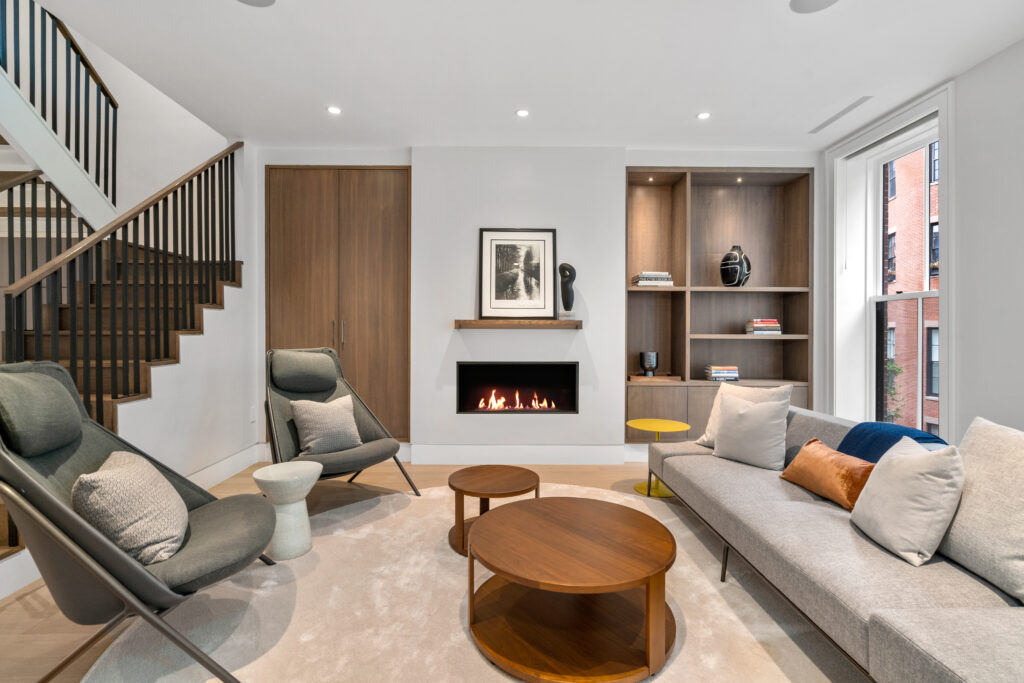 47 Hancock street living room and fireplace; Renovated kitchen at 47 Hancock Street, designed by ArnoldAnd to balance historic brownstone charm with modern functionality. Custom millwork and built-in storage solutions at 47 Hancock Street by ArnoldAnd. Reconfigured floor plan enhancing flow and functionality in this Boston brownstone renovation by ArnoldAnd.