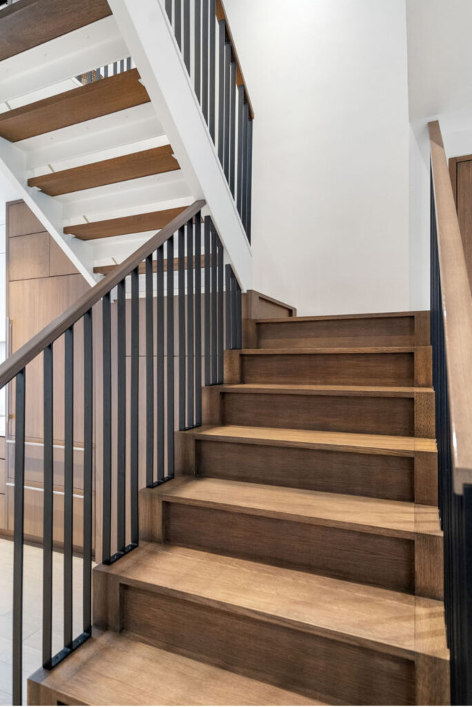 Hancock Kitchen stair detail UP; Renovated kitchen on Hancock Street, designed by ArnoldAnd to balance historic brownstone charm with modern functionality. Custom millwork and built-in storage solutions at 47 Hancock Street by ArnoldAnd. Reconfigured floor plan enhancing flow and functionality in this Boston brownstone renovation by ArnoldAnd.