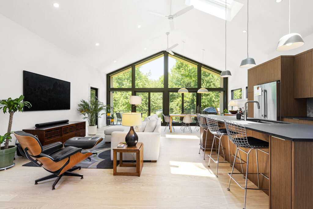 Reservoir House Kitchen and Living Room; Modern addition at Reservoir House, blending natural materials with expansive glazing for light-filled interiors. Open-plan living area at Reservoir House, showcasing ArnoldAnd’s approach to spatial flow and functional design. Seamless transition between historic structure and contemporary addition at Reservoir House by ArnoldAnd.