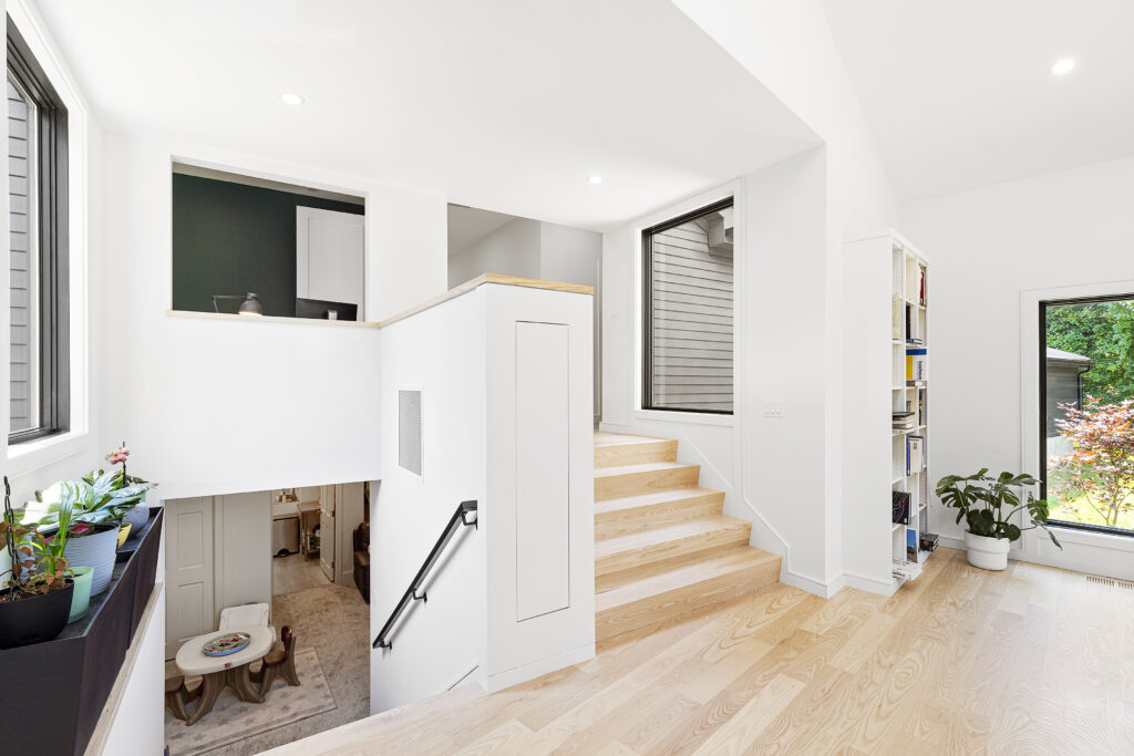 Reservoir House Interior Stair; Modern addition at Reservoir House, blending natural materials with expansive glazing for light-filled interiors. Open-plan living area at Reservoir House, showcasing ArnoldAnd’s approach to spatial flow and functional design. Seamless transition between historic structure and contemporary addition at Reservoir House by ArnoldAnd.