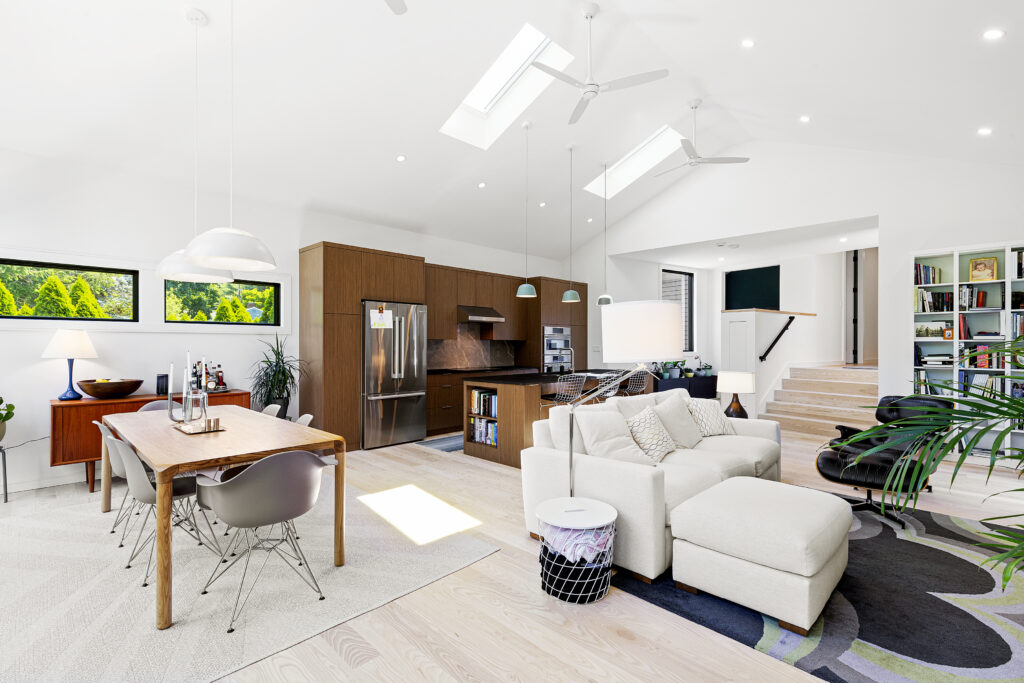 Modern addition at Reservoir House, blending natural materials with expansive glazing for light-filled interiors. Open-plan living area at Reservoir House, showcasing ArnoldAnd’s approach to spatial flow and functional design. Seamless transition between historic structure and contemporary addition at Reservoir House by ArnoldAnd.