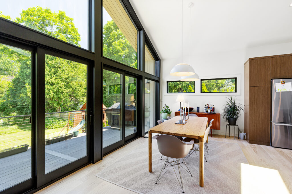 Reservoir House back door featureModern addition at Reservoir House, blending natural materials with expansive glazing for light-filled interiors. Open-plan living area at Reservoir House, showcasing ArnoldAnd’s approach to spatial flow and functional design. Seamless transition between historic structure and contemporary addition at Reservoir House by ArnoldAnd.