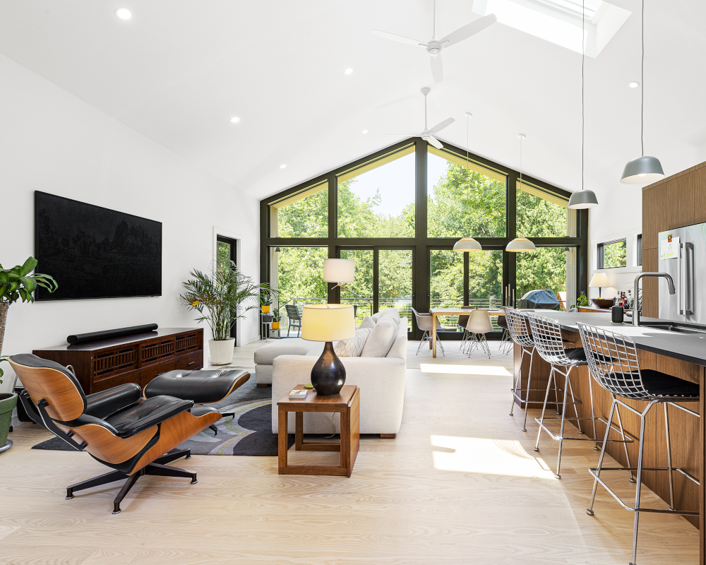 Reservoir House Kitchen and Living Room; Modern addition at Reservoir House, blending natural materials with expansive glazing for light-filled interiors. Open-plan living area at Reservoir House, showcasing ArnoldAnd’s approach to spatial flow and functional design. Seamless transition between historic structure and contemporary addition at Reservoir House by ArnoldAnd.