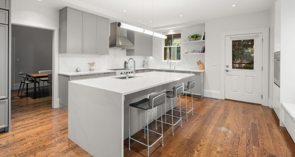 Modern kitchen renovation Newton MA with warm gray cabinetry and stone island