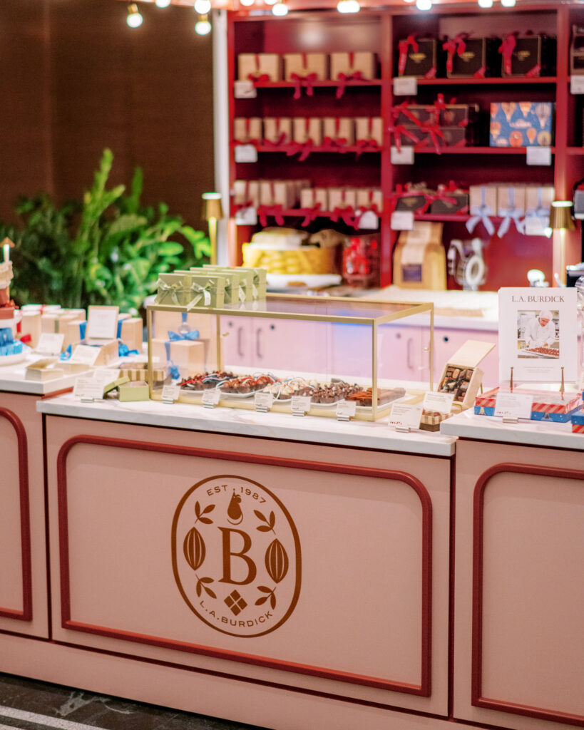 With its strategic placement in the main lobby, this micro-retail moment gives hotel guests and locals alike a reason to linger, and to indulge. Whether you're grabbing a gift box or a cup of the famous drinking chocolate, the experience feels special, tactile, and unmistakably Burdick.
